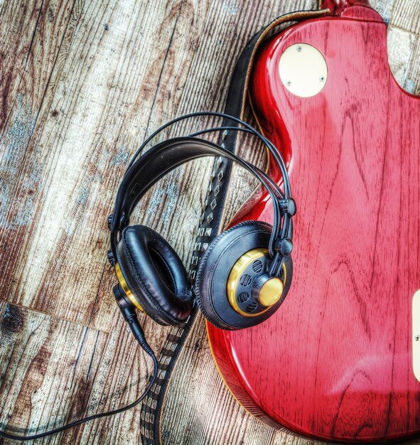 AKG K240 Studio headphones beside a tube amp – semi-open headphones for guitar amp tone testing.