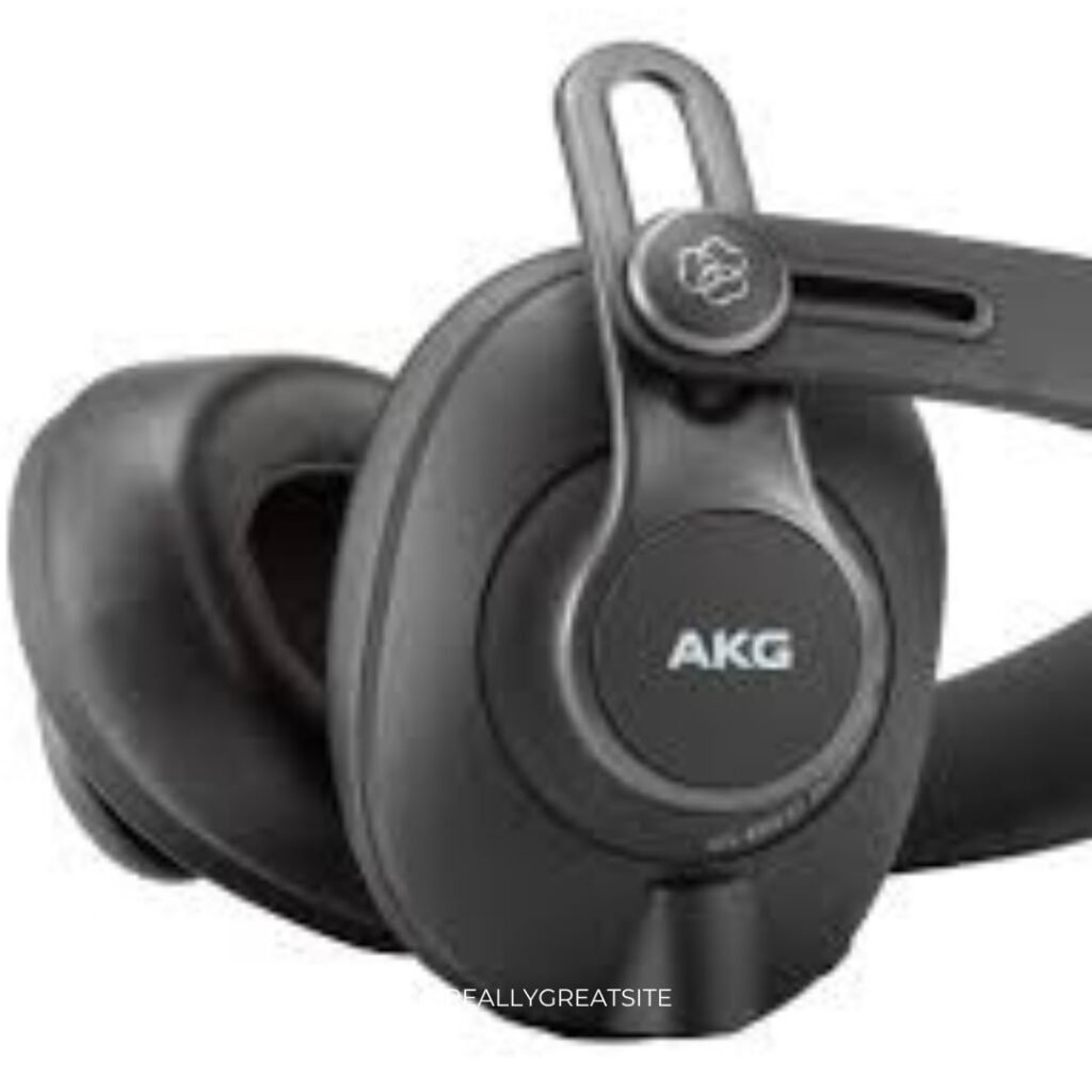 AKG K371 closed-back headphones resting on amp knobs – reference-grade headphones for guitar amp accuracy.
